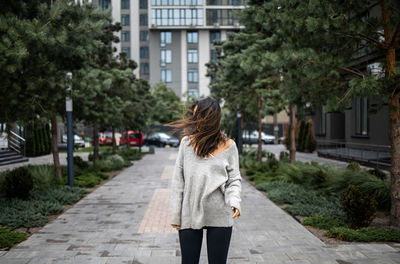 Young woman on a windy day. wind blowing hair.