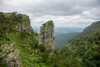 Scenic view of mountains against cloudy sky