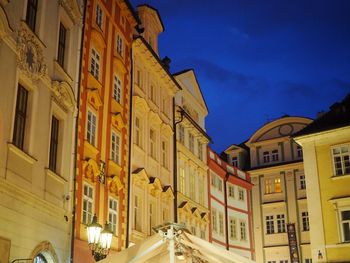 Low angle view of illuminated buildings against sky at dusk