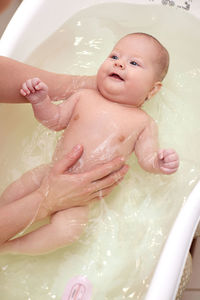 High angle view of woman washing hands in sink