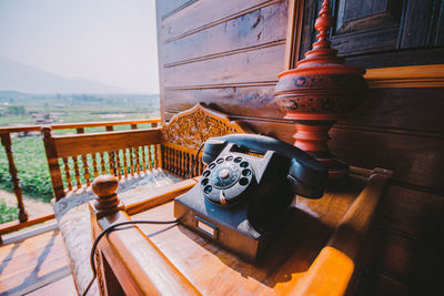 Close-up of old telephone booth on table