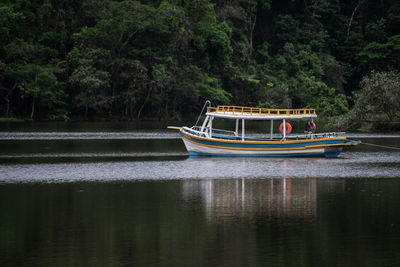 Boat sailing on river in forest