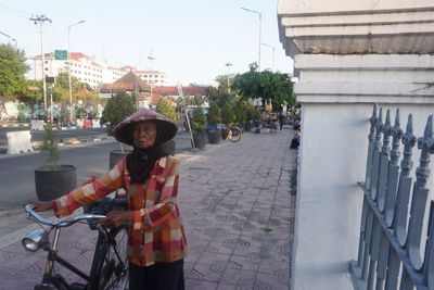 Portrait of man riding bicycle in city