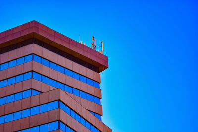 Low angle view of building against clear blue sky