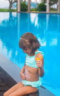 Side view of boy playing in pool