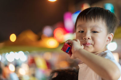 Portrait of boy holding mobile phone