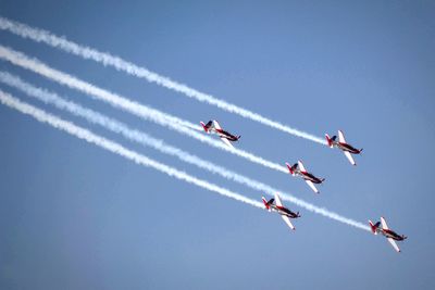 Low angle view of airshow against sky