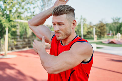 Side view of young man exercising at park