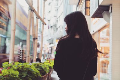 Woman looking up at store