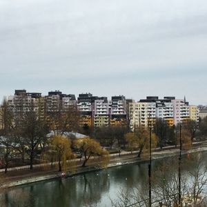 City by river against sky