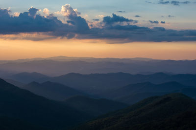 Scenic view of silhouette mountains against sky at sunset