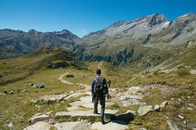 Rear view of man walking on mountain