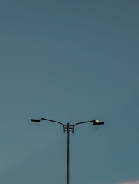 Low angle view of security camera against clear sky