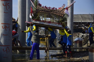 People working in front of built structure