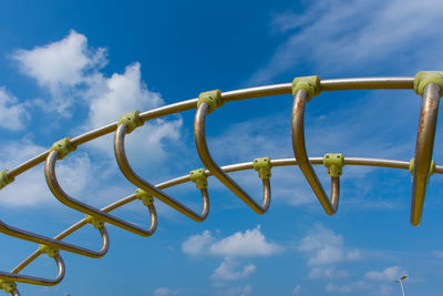 Low angle view of chain against sky