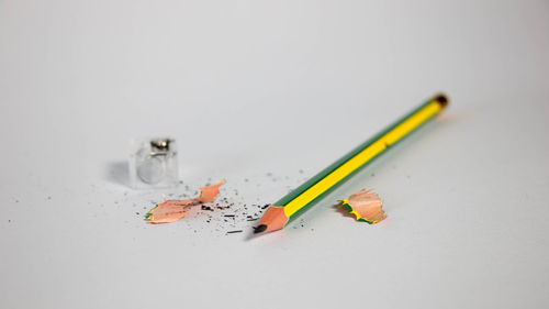 High angle view of colored pencils against white background