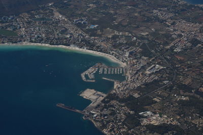 High angle view of city by sea and buildings