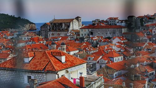 High angle view of buildings in town against sky