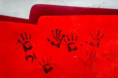 Close-up of text on red wall