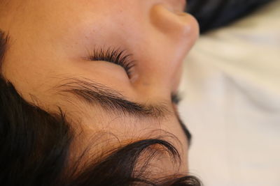 Close-up of young man sleeping at home 