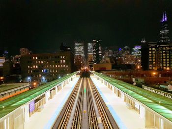 High angle view of illuminated buildings against sky at night