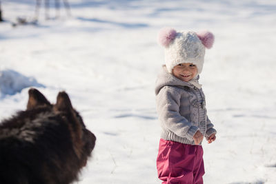 Boy standing in snow