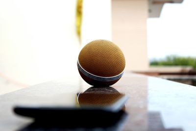 Close-up of smart phone and bluetooth speaker at balcony