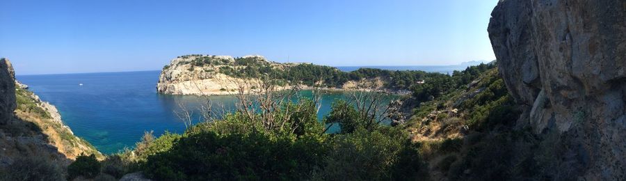 Panoramic shot of sea against clear blue sky