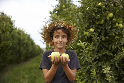 Portrait of a kid in an apple plantation
