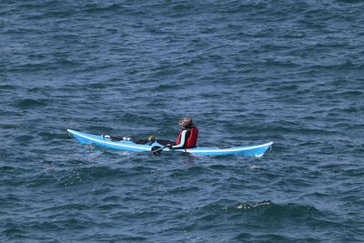 Rear view of man surfing in sea