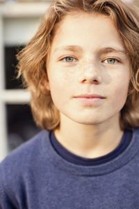 Portrait of confident boy in back yard