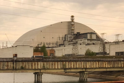 View of factory against sky during sunset