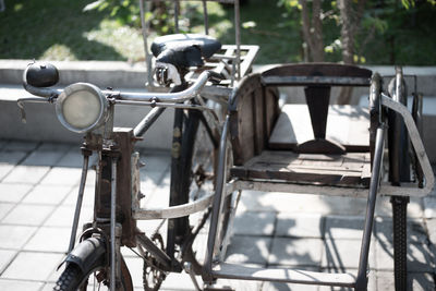 Close-up of bicycle parked by railing