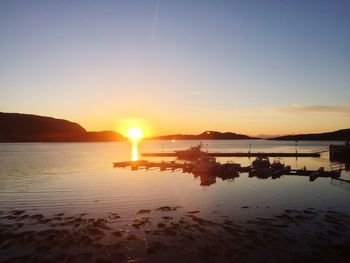 Scenic view of calm lake at sunset