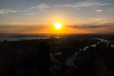 High angle view of buildings against romantic sky at sunset