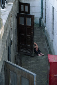 Low section of woman standing on wooden building