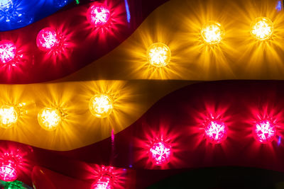 Low angle view of illuminated lights hanging from ceiling