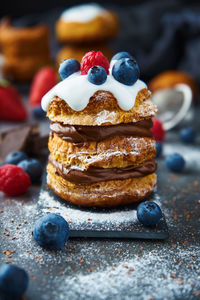 Sweet puff pastry with chocolate filling and accompanied by blueberries and raspberries