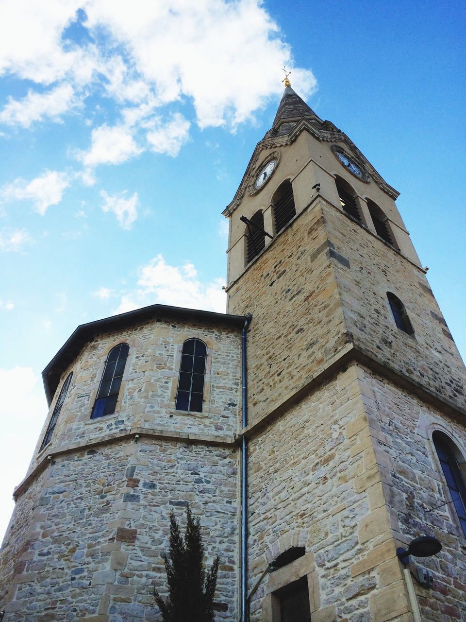 architecture, building exterior, built structure, low angle view, sky, window, tower, tall - high, blue, day, outdoors, no people, high section, building, city, cloud, sunlight, clock tower, history, church