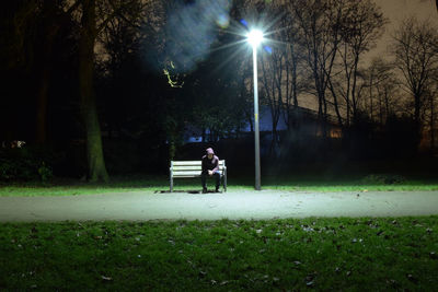 People sitting on street at night