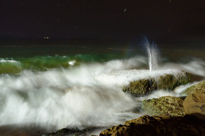 Water splashing on rocks at sea shore