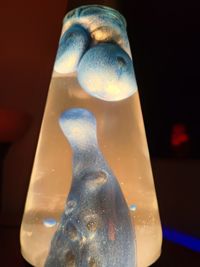 Close-up of glass bottle against black background