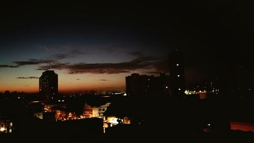 High angle view of illuminated buildings against sky at night