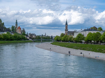 Scenic view of river and evangelical parish salzburg christ church in the distance