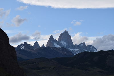 Scenic view of mountains against cloudy sky