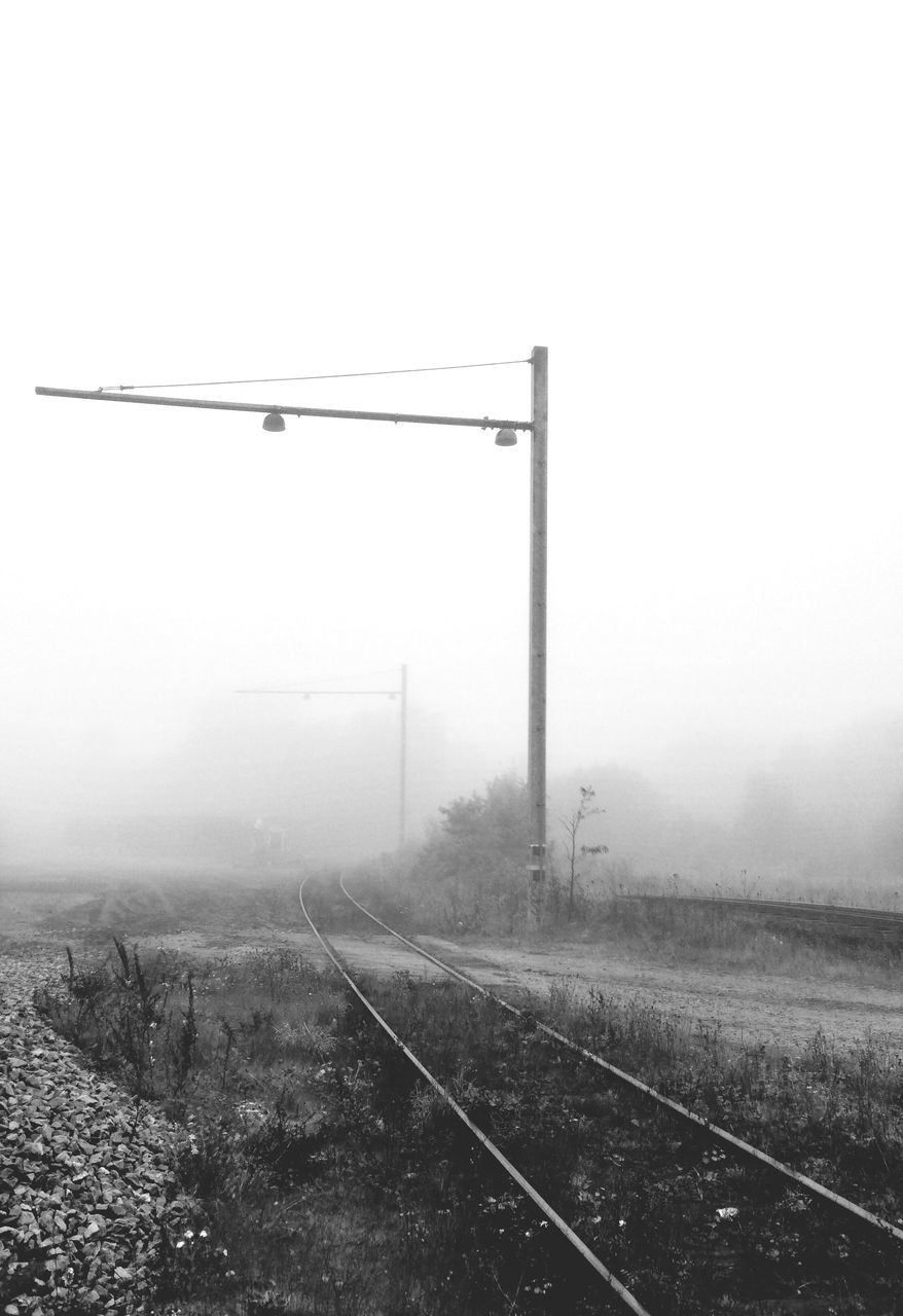 fog, foggy, weather, railroad track, transportation, field, landscape, copy space, rail transportation, public transportation, sky, electricity pylon, day, nature, connection, no people, tranquility, mist, built structure