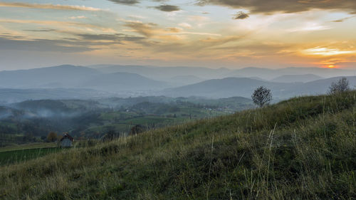 Scenic view of field against sky during sunset