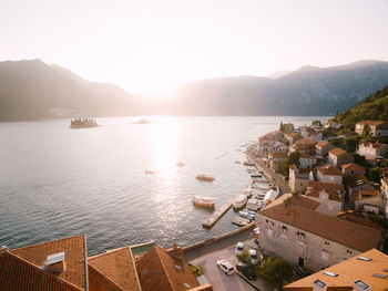 High angle view of buildings by sea against sky