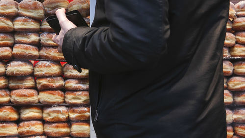 Low section of man standing by food