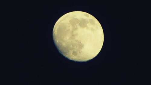 Low angle view of moon against black sky